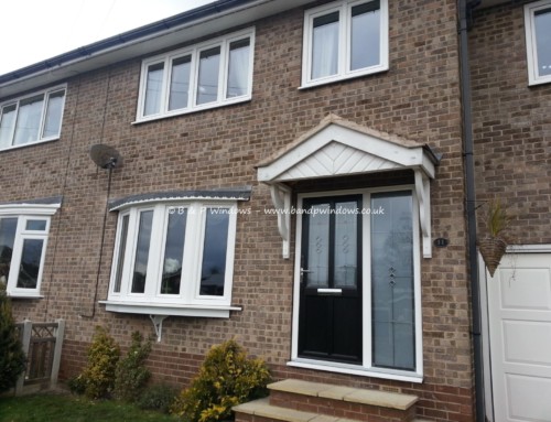 Black engineered door with sidelight and windows